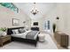 Bright main bedroom featuring a statement chandelier, ensuite bathroom, and private access to the backyard at 910 Kingscote Ct, Safety Harbor, FL 34695