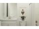 Well-lit bathroom featuring a vanity with a marble countertop, modern fixtures, and neutral decor at 9509 Minnow Ray Dr, Land O Lakes, FL 34638