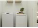 Convenient laundry area equipped with a washer, a dryer, and built-in storage for organization at 9509 Minnow Ray Dr, Land O Lakes, FL 34638