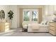 Bright and airy main bedroom with large windows, light-colored furniture, and natural accents at 9509 Minnow Ray Dr, Land O Lakes, FL 34638