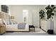 Stylish main bedroom showcasing a decorative headboard, nightstands, and a bench at the end of the bed at 9509 Minnow Ray Dr, Land O Lakes, FL 34638