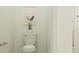 Cozy powder room with stylish fixtures, a modern toilet, and neutral decor at 9509 Minnow Ray Dr, Land O Lakes, FL 34638