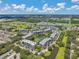 Scenic aerial view of condo buildings with landscaping, ponds, and golf course at 960 Starkey Rd # 10505, Largo, FL 33771