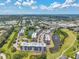 Scenic aerial view of buildings surrounded by lush trees, pond and landscaping at 960 Starkey Rd # 10505, Largo, FL 33771