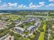 Scenic aerial view of condo buildings with landscaping, ponds, and golf course at 960 Starkey Rd # 10505, Largo, FL 33771