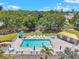 Aerial view of a resort-style pool with lush landscaping and a nearby lake at 960 Starkey Rd # 10505, Largo, FL 33771