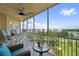 Screened balcony with seating, ceiling fan and views of the beautiful landscape at 960 Starkey Rd # 10505, Largo, FL 33771