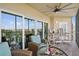 Screened balcony with seating, ceiling fan and beautiful views of the area at 960 Starkey Rd # 10505, Largo, FL 33771