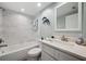 Bright bathroom features a tub with a shower and a white vanity with a light countertop at 960 Starkey Rd # 10505, Largo, FL 33771
