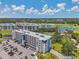 A multi-story condo boasts balconies with golf course views, lush landscaping, and parking in this beautiful Florida community at 960 Starkey Rd # 10505, Largo, FL 33771