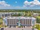 A beautiful six-story condo building that features balconies and an expansive view of a golf course with a small lake at 960 Starkey Rd # 10505, Largo, FL 33771