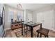 Dining area with wood-look floors, shutters, and a stylish rug under a seating table with stools at 960 Starkey Rd # 10505, Largo, FL 33771