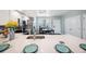 Modern kitchen with stainless steel appliances, island table, and sleek countertops at 960 Starkey Rd # 10505, Largo, FL 33771