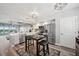 Kitchen with white cabinetry, stainless steel appliances, and a cozy dining area with breakfast table at 960 Starkey Rd # 10505, Largo, FL 33771
