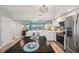 Modern kitchen with stainless steel appliances and center island open to living area at 960 Starkey Rd # 10505, Largo, FL 33771