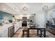 Updated kitchen featuring stainless appliances, a dining table, and modern lighting fixtures at 960 Starkey Rd # 10505, Largo, FL 33771