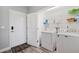 Bright laundry room with full size washer and dryer, shelving and vinyl flooring at 960 Starkey Rd # 10505, Largo, FL 33771