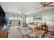 Bright living room with comfortable seating, modern ceiling fans, and sliding glass doors to a balcony at 960 Starkey Rd # 10505, Largo, FL 33771