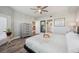The main bedroom has gray wood flooring, a ceiling fan and balcony access at 960 Starkey Rd # 10505, Largo, FL 33771