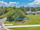 A sign displaying 'Golf Lake Condominiums at East Bay,' is nestled amidst lush landscaping and greenery at 960 Starkey Rd # 10505, Largo, FL 33771