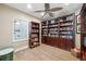 Cozy study with dark wood shelving, wood floors, and a view into the kitchen at 960 Starkey Rd # 10505, Largo, FL 33771