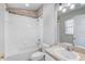 Bright bathroom featuring a shower-tub combo, toilet, and vanity, creating a functional and clean space at 9907 Carlsdale Dr, Riverview, FL 33578