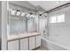 Bathroom featuring double sinks, modern vanity, tub and shower with tiled surround at 9907 Carlsdale Dr, Riverview, FL 33578