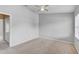 This is a spacious bedroom with neutral walls, carpet, and an ceiling fan at 9907 Carlsdale Dr, Riverview, FL 33578