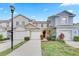 Charming townhome featuring a red front door, a two-car garage, and well-maintained landscaping and lawn at 9907 Carlsdale Dr, Riverview, FL 33578