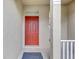 Inviting front entrance featuring a bold red door and neutral exterior at 9907 Carlsdale Dr, Riverview, FL 33578