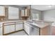 Modern kitchen with stainless steel dishwasher, double sink, and ample counter space at 9907 Carlsdale Dr, Riverview, FL 33578