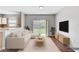 Cozy living room boasts hardwood floors, neutral paint and view to outdoor space at 9907 Carlsdale Dr, Riverview, FL 33578