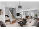 Open concept living room with modern decor and staircase to the upper level at 9907 Carlsdale Dr, Riverview, FL 33578