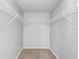 Spacious walk-in closet with carpet and wire shelving, perfect for organized storage solutions in your new home at 9907 Carlsdale Dr, Riverview, FL 33578
