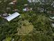 Expansive acreage with barn and paddocks surrounded by lush trees, ready for development at 10930 Spring St, Largo, FL 33774