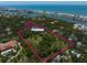 Expansive property with lush acreage outlined in pink, featuring a barn and potential for development at 10930 Spring St, Largo, FL 33774