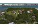 Waterfront property boasts lush trees and vegetation with boat docks along the shore at 10930 Spring St, Largo, FL 33774