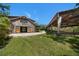 A rustic barn with large doors, a well-maintained field, and covered area for horses or storage at 10930 Spring St, Largo, FL 33774