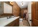 Bathroom features stone accent wall and decorative shower curtain at 10930 Spring St, Largo, FL 33774