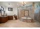 Elegant bathroom featuring mosaic tile details, a curved bathtub, walk-in shower, and a vanity at 10930 Spring St, Largo, FL 33774