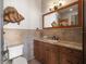 Charming bathroom with beautiful wood vanity, granite countertops, designer mirror, decorative lighting, and tile floors at 10930 Spring St, Largo, FL 33774