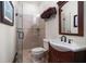 Cozy bathroom featuring a glass-enclosed shower and dark wood vanity and a mirror at 10930 Spring St, Largo, FL 33774