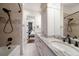 Clean bathroom with white cabinets, granite counters, and tiled shower, offering a modern and comfortable space at 10930 Spring St, Largo, FL 33774