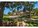 Stately home featuring a circular driveway and lush landscaping at 10930 Spring St, Largo, FL 33774