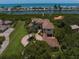Stunning waterfront home with lush landscaping, circular driveway, and beautiful tile roof at 10930 Spring St, Largo, FL 33774