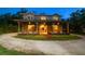 Rustic barn-style home with a covered front porch, stone accents, and ample outdoor space, blending charm and functionality at 10930 Spring St, Largo, FL 33774