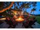 Inviting outdoor fire pit with seating, perfect for gatherings and enjoying the evening at 10930 Spring St, Largo, FL 33774