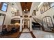 Open-concept floor plan, with a view of the foyer, piano, dining room, and curved staircase at 10930 Spring St, Largo, FL 33774