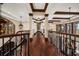 Elegant hallway with dark wood floors, decorative columns, and coffered ceilings, creating a grand entrance at 10930 Spring St, Largo, FL 33774