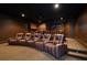 Home theater room featuring multiple leather reclining seats, projector screen, and dark ambiance at 10930 Spring St, Largo, FL 33774